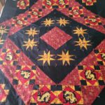 Red, black and gold quilt with dragons